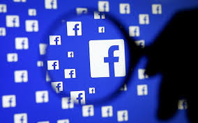 Facebook logo under magnifying glass